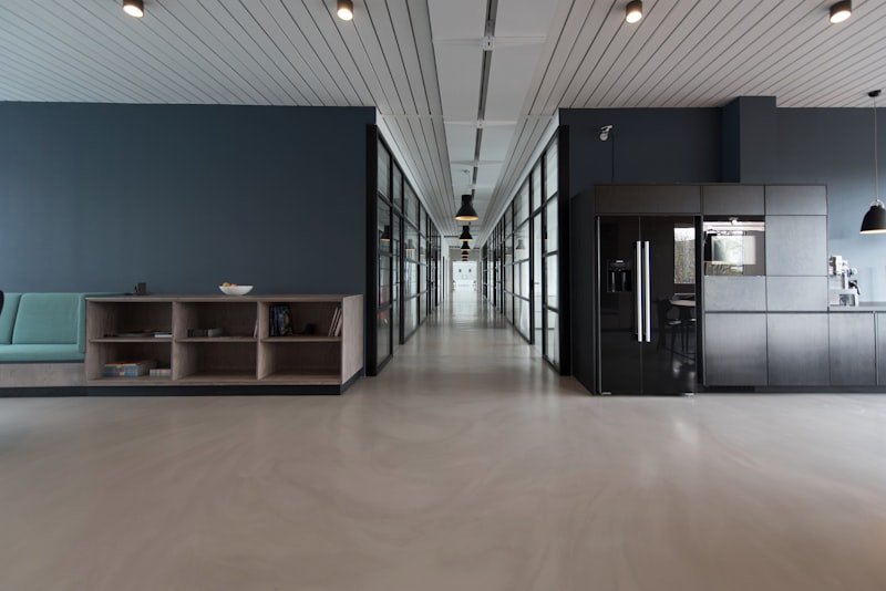 Modern office corridor with glass-walled meeting rooms