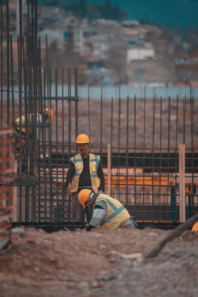 Construction workers installing rebar at a site in Nepal; rebar is covered by Nepal's special price adjustment