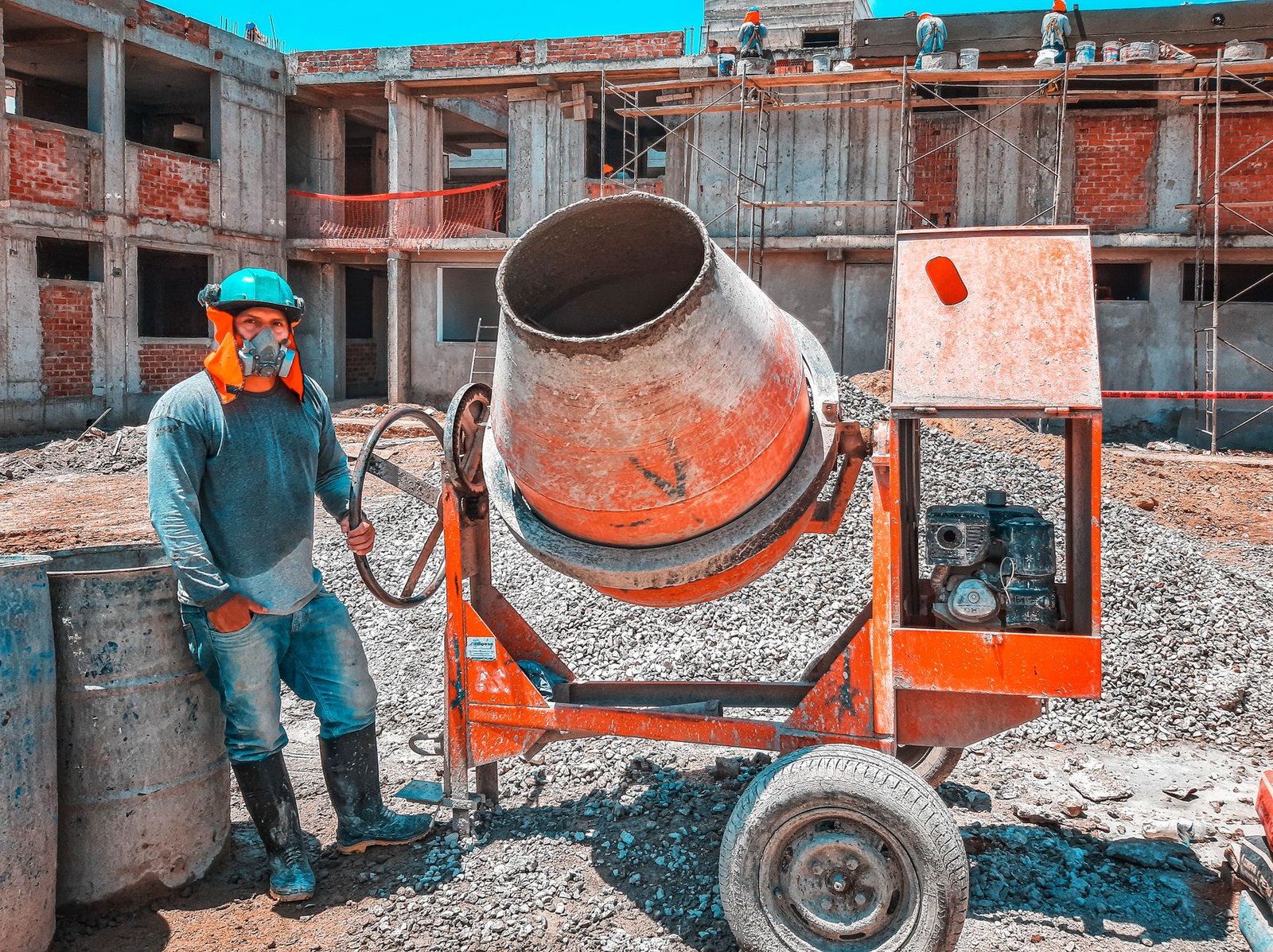 Construction worker operating a concrete mixer at a building site, illustrating the PPMO beta e-GP website news story