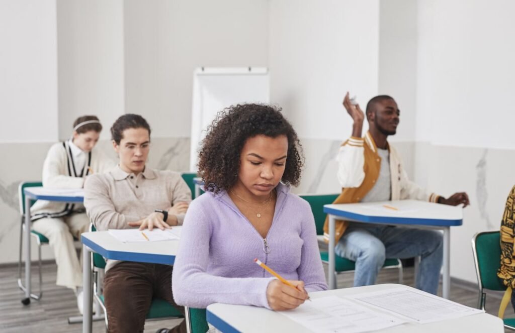 Diverse students taking a written license exam in a classroom setting